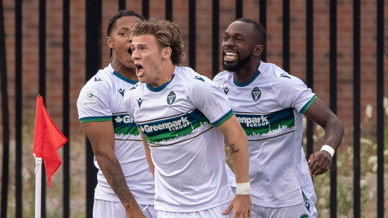 Ronan Kratt (middle) celebrates with teammates after scoring against Pacific in 2022 (Photo credit: John Jacques / Northern Tribune)