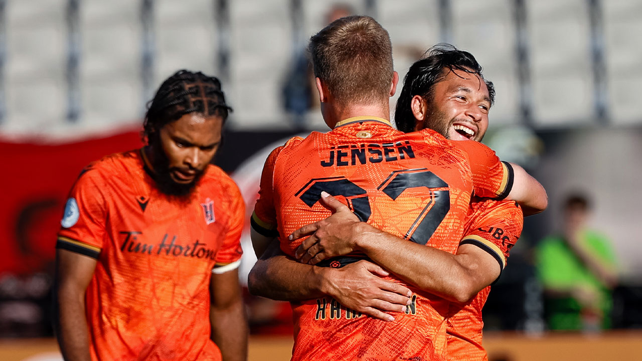 Noah Jensen celebrates with David Choinière after scoring Forge FC's 3rd goal of the night against Vancouver FC on September 21, 2024 (Photo credit: Gordon Kalisch / FastTrackSportsPhotography)